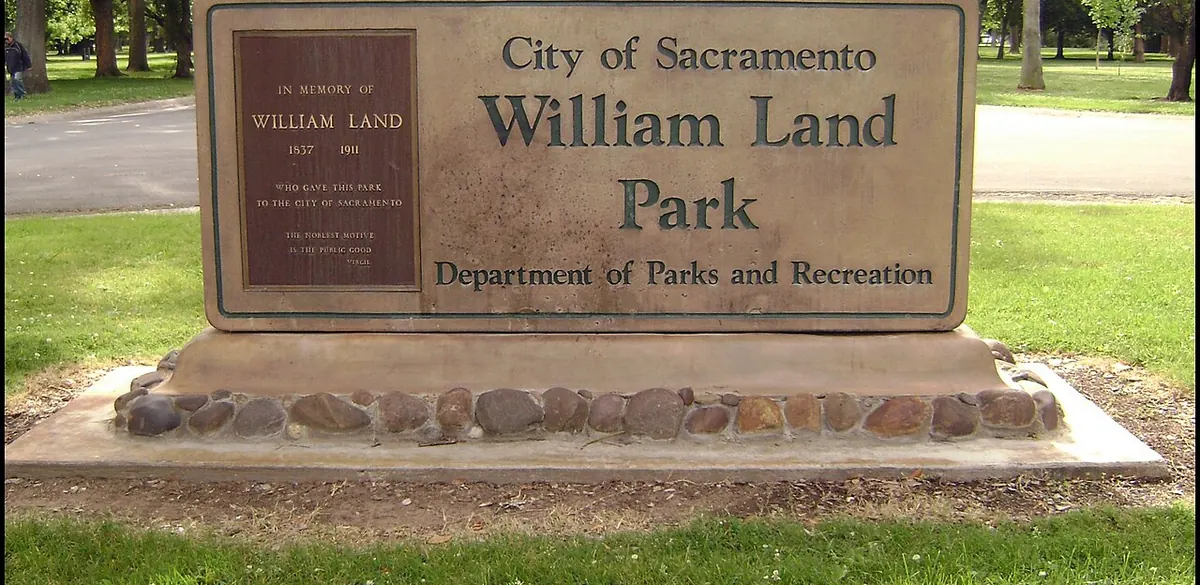 The entrance sign and trees at William Land Regional Park in Sacramento.