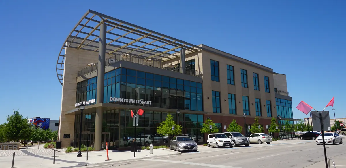 Exterior of George W. Hawkes Downtown Library in Arlington, with its name above the entrance.