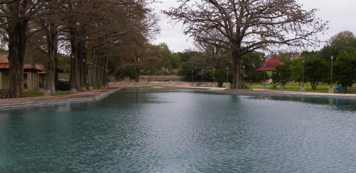 The pool and surrounding trees at San Pedro Springs Park in San Antonio.